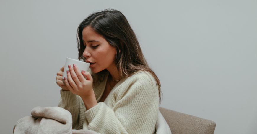 woman drinking herbal tea natural remedy for cycle